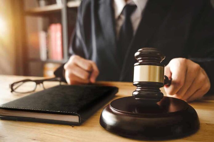 1035925210 featured image Gavel on table with glasses and notebook