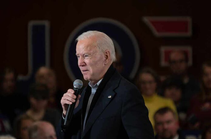 1641343303 featured image Man speaking into a microphone at an event.