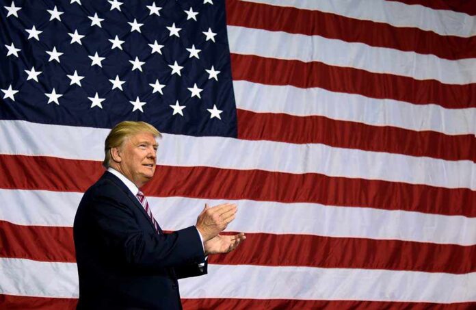 1848623440 featured image Man clapping in front of large American flag