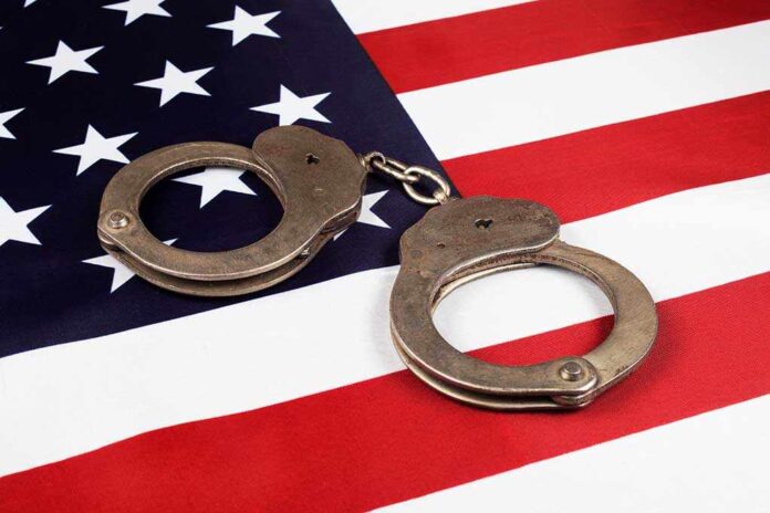 1904324953 featured image Handcuffs on an American flag.