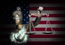 Blindfolded Lady Justice in front of American flag