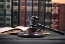 Gavel and open book in library setting