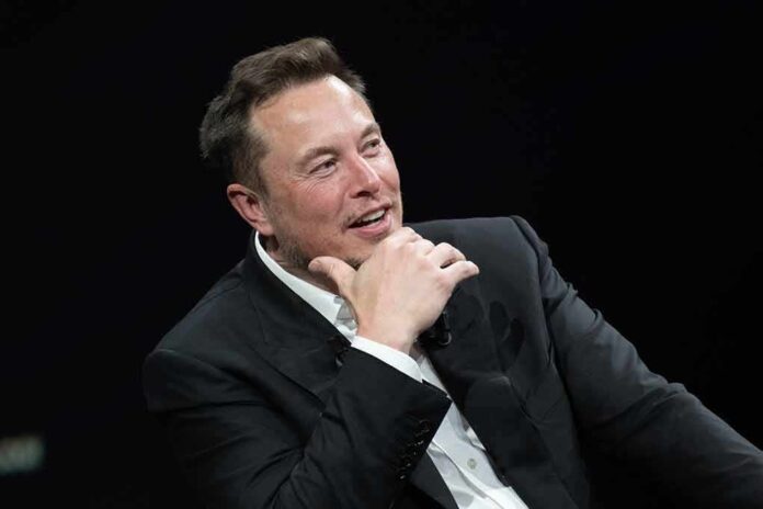 2318800327 featured image Man in black suit smiling, hand on chin.