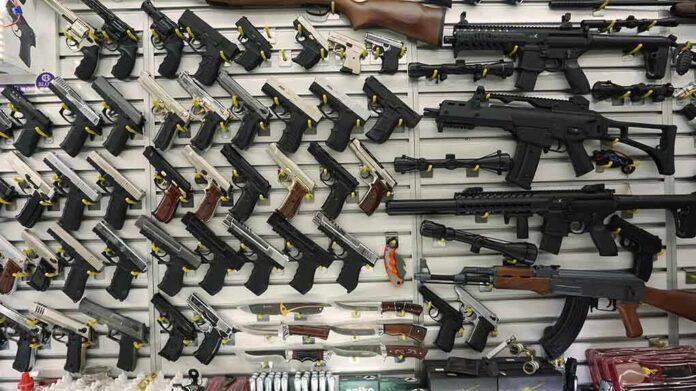1096565819 featured image Wall display with handguns and rifles for sale