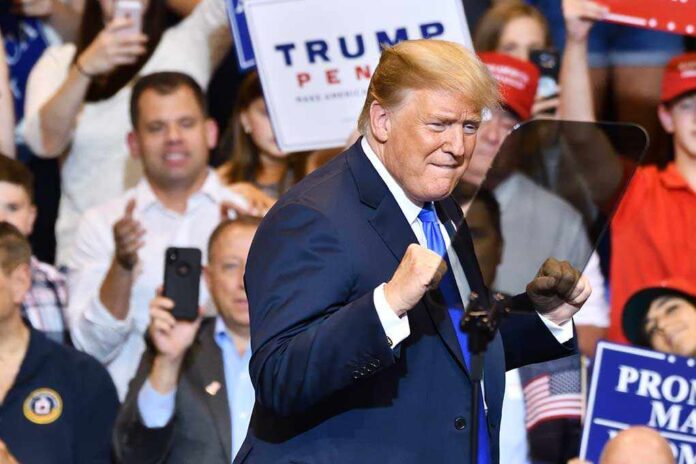 1148319815 featured image Man in suit standing at a rally event