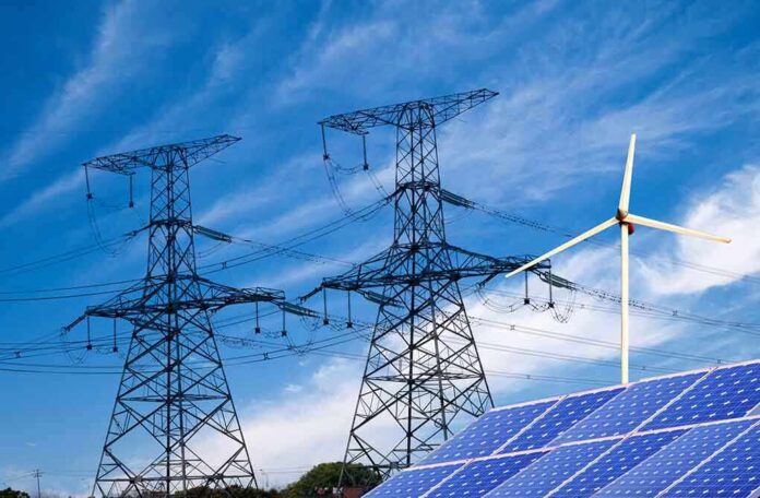 138865700 featured image Power lines solar panels and wind turbine against sky