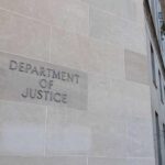 Department of Justice building with American flags.
