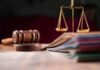 Judges gavel scales of justice and legal documents