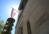 "American flag at Department of Justice building exterior."