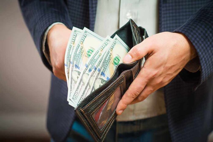 253526959 featured image Person holding wallet with cash inside