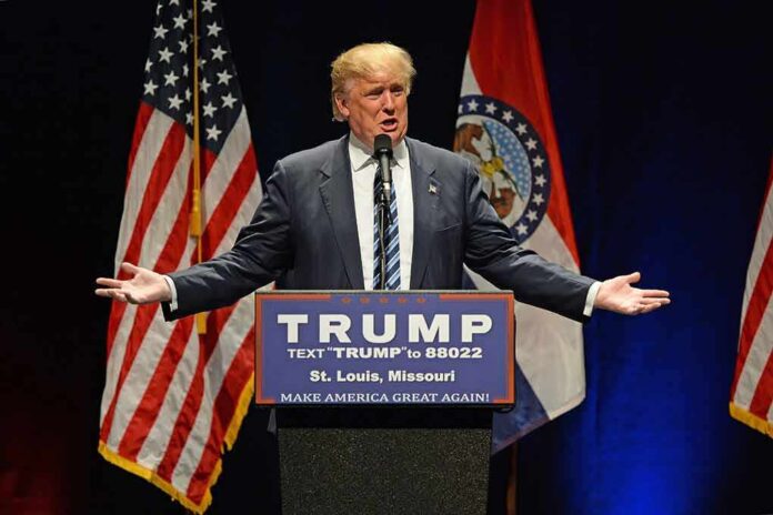 389315497 featured image Man speaking at podium with American flags behind.