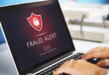 Laptop displaying fraud alert warning on screen