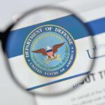 Magnifying glass over Department of Defense logo