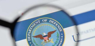Magnifying glass over Department of Defense logo