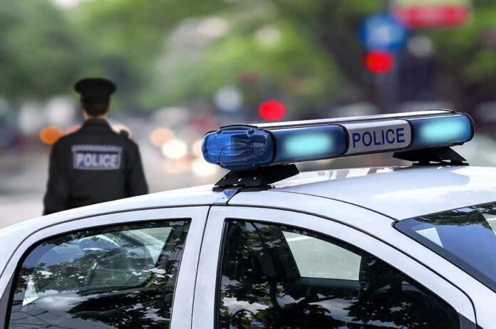Police car and officer on a city street