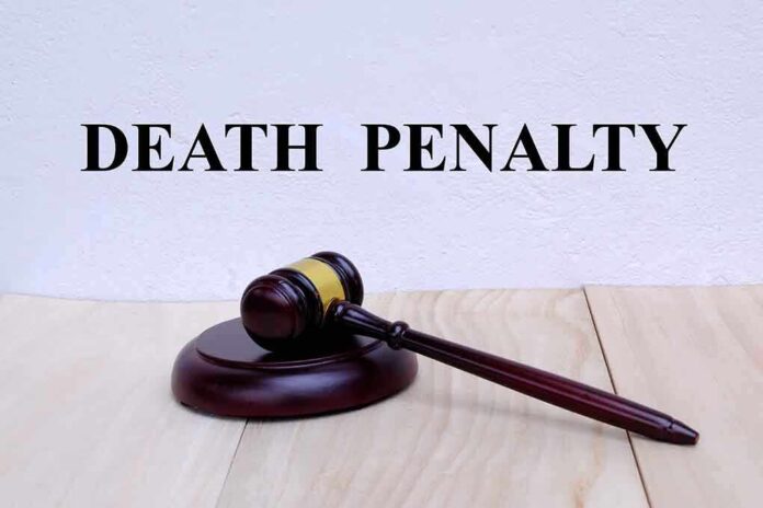 Gavel under "Death Penalty" text on white background. featured image Gavel under "Death Penalty" text on white background.