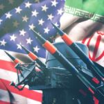 Iran and USA flags with missile launcher