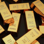 Gold bars stacked on dark background