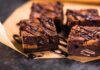 Chocolate brownies with drizzled chocolate on parchment paper