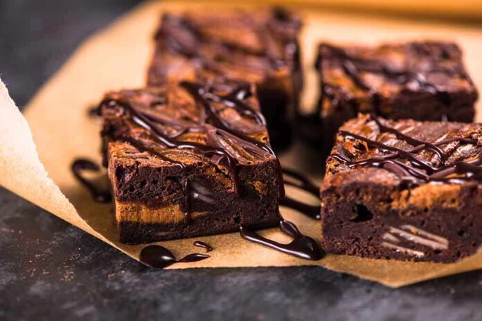 329455271 featured image Chocolate brownies with drizzled chocolate on parchment paper