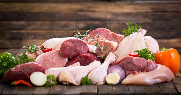 497502007 Assorted raw meat with vegetables on wooden table