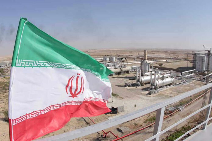 Iranian flag near an industrial gas refinery