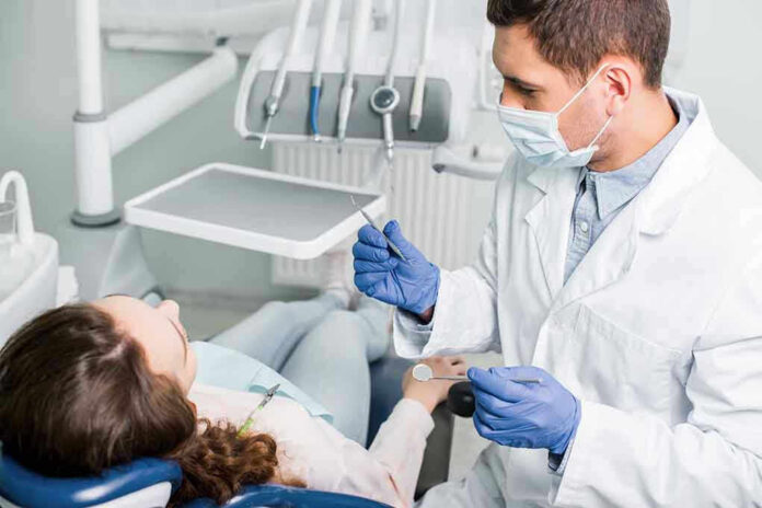 Dentist examining a patient in a dental chair