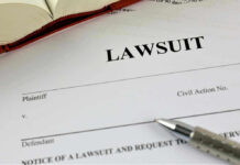 Lawsuit paperwork with pen and open book