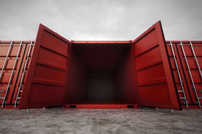 Open red shipping container with a view into the empty interior