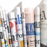 Shocking $6.2 Billion Power Grab—Conservatives Concerned A collection of rolled newspapers displaying various headlines and designs