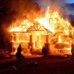 TIED UP and Burned — Unthinkable Cruelty House engulfed in flames with firefighters present.