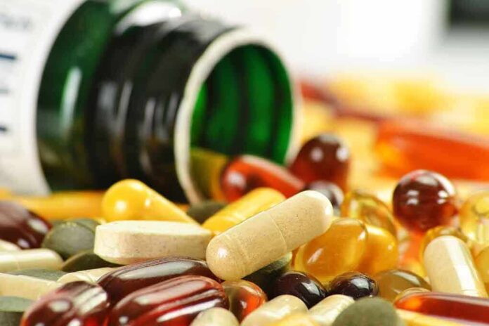 Assorted vitamins and supplements scattered around an overturned bottle