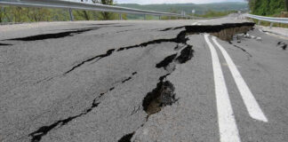 Road damaged by significant cracks and fissures.