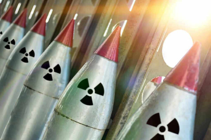 1090003628 Line of nuclear missiles with radiation hazard signs.