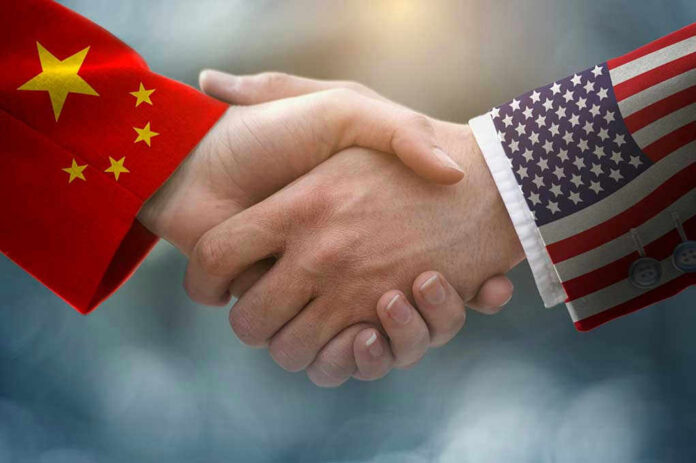 1431101585 Chinese and American flag sleeves shaking hands.