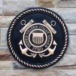 Bronze emblem of the United States Coast Guard mounted on a stone wall