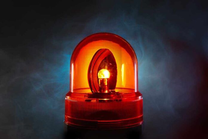 shutterstock_71028904.jpg An illuminated orange emergency light on a dark background