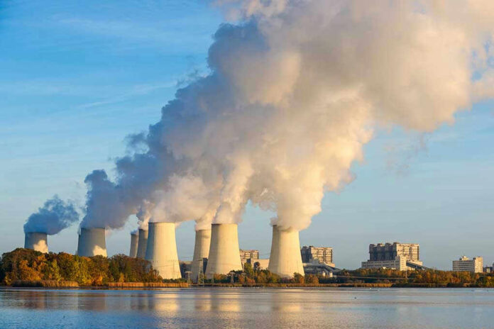 Nuclear power plant cooling towers emitting steam.