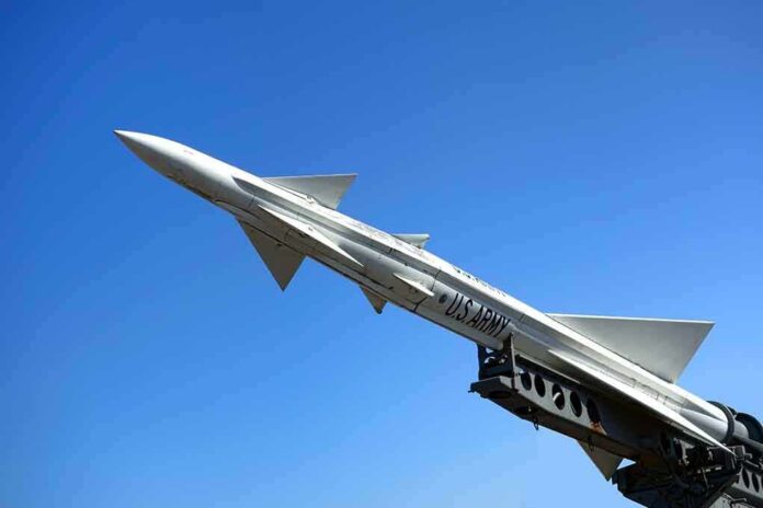 A military missile pointed upwards against a clear blue sky