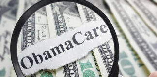Magnifying glass over Obamacare text and money