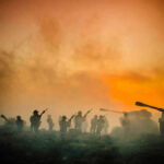 Soldiers and tanks in the foggy battlefield.