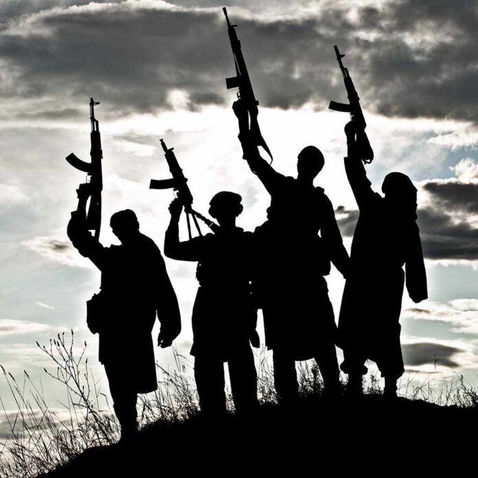 Silhouetted figures holding rifles against a cloudy sky