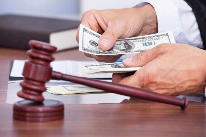 A person counting cash in a courtroom setting with a gavel in the foreground