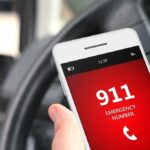 Barron Trump’s Heroic 2AM Call Saves Life A smartphone displaying the emergency number 911 while held in a persons hand inside a car