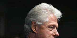 Profile portrait of a man with gray hair in formal attire