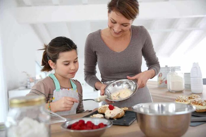 shutterstock_176503001.jpg A mother and daughter baking together in a bright kitchen