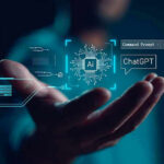 Hand holding digital AI and ChatGPT graphics.