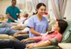 A nurse smiling at a female donor during a blood donation session