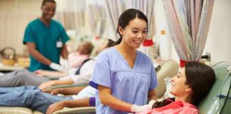 A nurse smiling at a female donor during a blood donation session