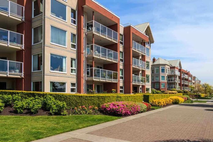 Modern apartment buildings with balconies and landscaped gardens on a sunny day